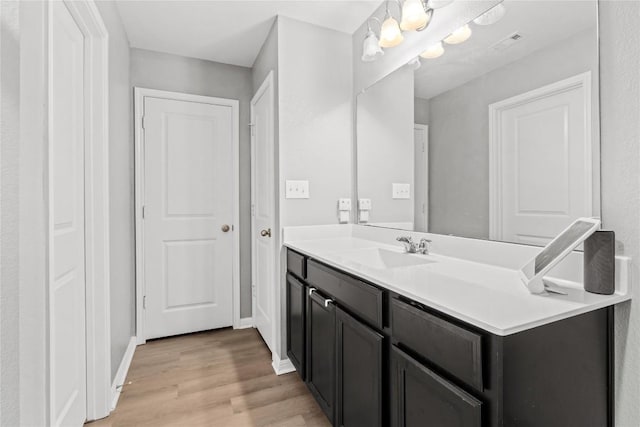 509 Peony Ct, Jarrell, TX 76537 - bathroom with vanity, baseboards, and wood finished floors