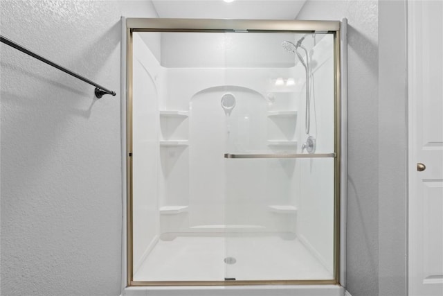 509 Peony Ct, Jarrell, TX 76537 - bathroom featuring a textured wall and a stall shower