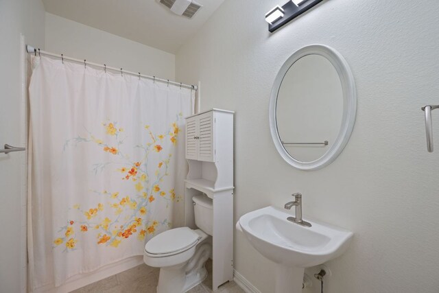 13305 Kinder Pass, Austin, TX 78727 - full bathroom with a sink, toilet, and tile patterned flooring