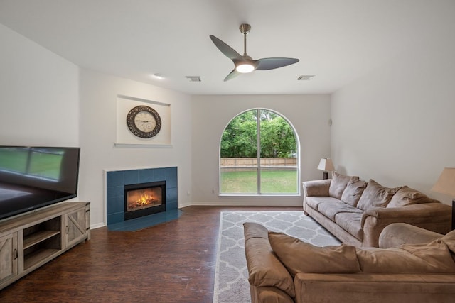 13305 Kinder Pass, Austin, TX 78727 - living room featuring dark wood-style floors, a tile fireplace, ceiling fan, and baseboards