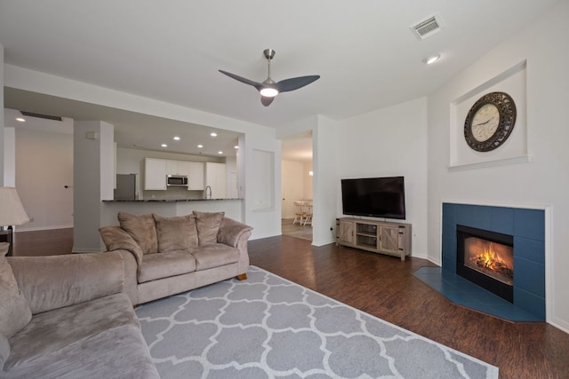 13305 Kinder Pass, Austin, TX 78727 - living area with dark wood finished floors, a ceiling fan, baseboards, a tile fireplace, and recessed lighting