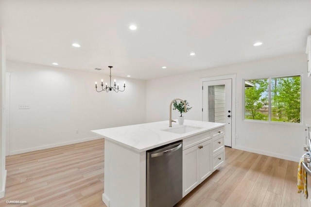 kitchen featuring stainless steel dishwasher, a sink, white cabinetry, and light wood-type flooring