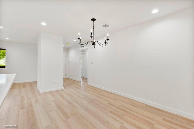 unfurnished dining area featuring visible vents, recessed lighting, a chandelier, and light wood-type flooring