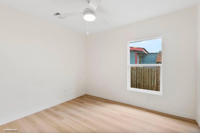 unfurnished room featuring baseboards, a ceiling fan, and light wood finished floors