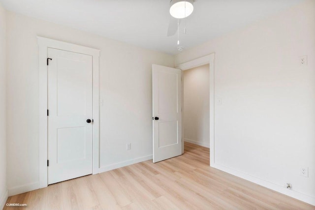 unfurnished bedroom featuring baseboards and light wood-type flooring