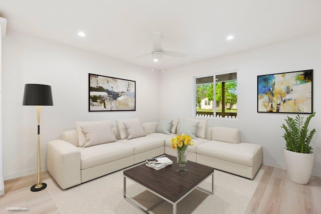living area with recessed lighting, a ceiling fan, and wood finished floors