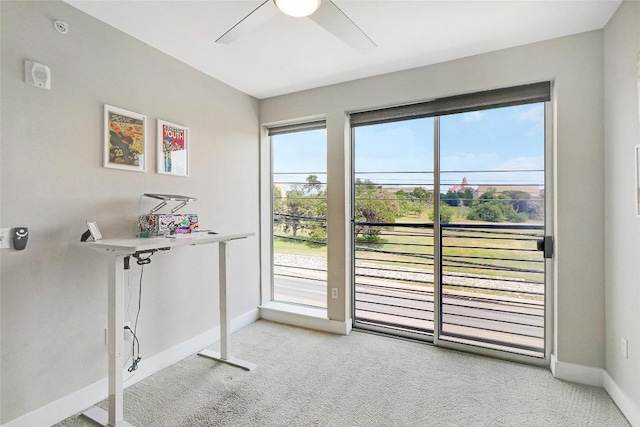 entryway featuring baseboards, ceiling fan, and light carpet