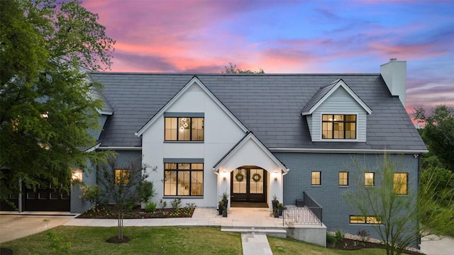 4203 Balcones Dr, Austin, TX 78731 - view of front of home featuring french doors, a chimney, brick siding, and a front yard