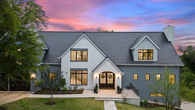 4203 Balcones Dr, Austin, TX 78731 - view of front of property with french doors, a chimney, brick siding, and a front lawn