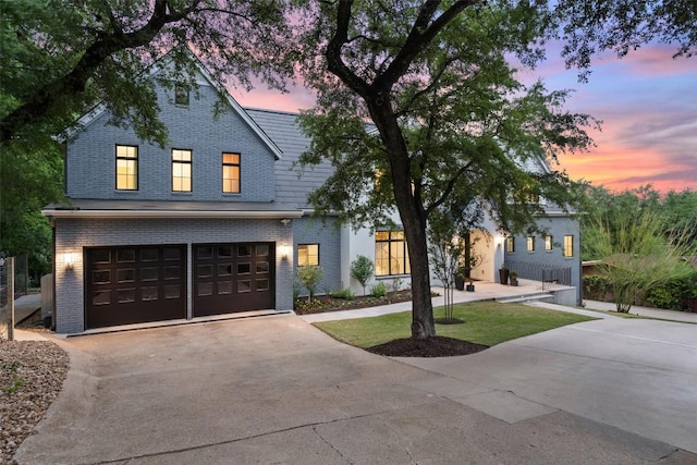 4203 Balcones Dr, Austin, TX 78731 - view of front of home with brick siding, driveway, and an attached garage
