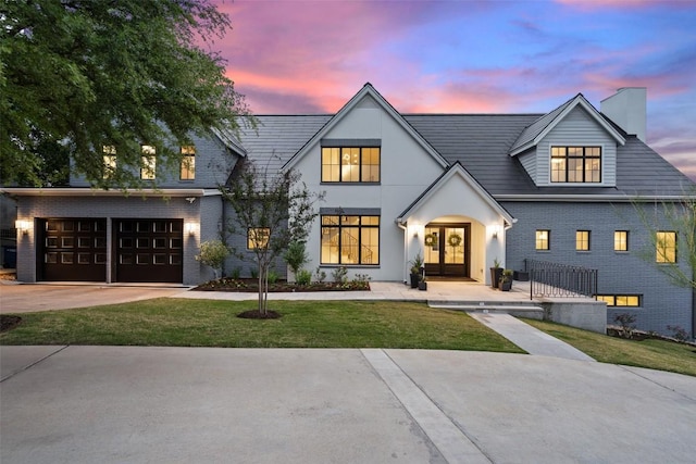 4203 Balcones Dr, Austin, TX 78731 - view of front facade featuring french doors, an attached garage, a chimney, a yard, and concrete driveway
