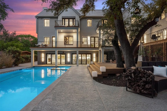 4203 Balcones Dr, Austin, TX 78731 - back of house with a balcony, a patio, an outdoor pool, and an outdoor living space