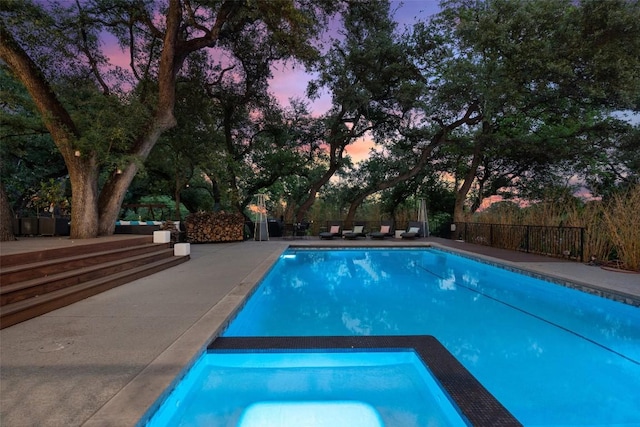 4203 Balcones Dr, Austin, TX 78731 - pool at dusk featuring a pool with connected hot tub