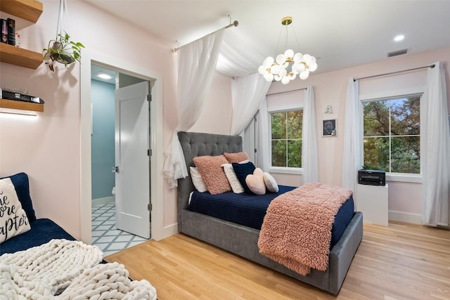 4203 Balcones Dr, Austin, TX 78731 - bedroom featuring a chandelier, wood finished floors, baseboards, recessed lighting, and ensuite bathroom