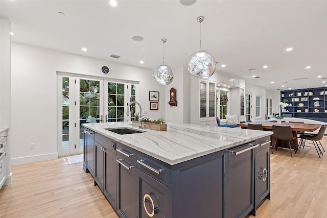 4203 Balcones Dr, Austin, TX 78731 - kitchen featuring french doors, light wood-style floors, a kitchen island with sink, and recessed lighting