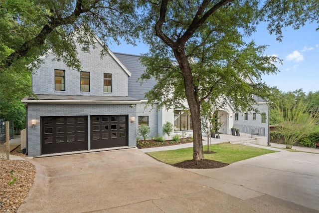 4203 Balcones Dr, Austin, TX 78731 - view of front of property featuring brick siding, driveway, and a garage