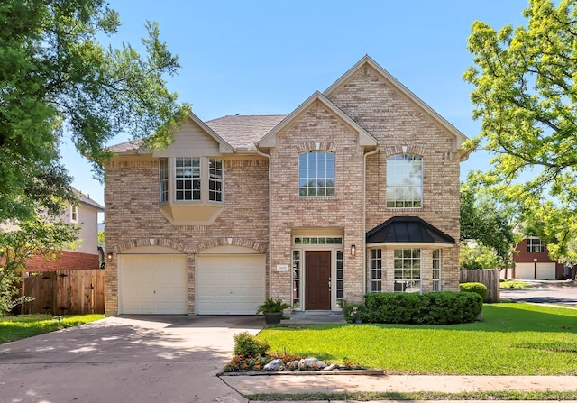 1809 Johnson Way, Round Rock, TX 78681 - traditional-style home with a garage, fence, a front yard, brick siding, and driveway