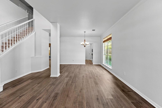 1809 Johnson Way, Round Rock, TX 78681 - unfurnished living room with an inviting chandelier, stairway, dark wood-style flooring, and crown molding