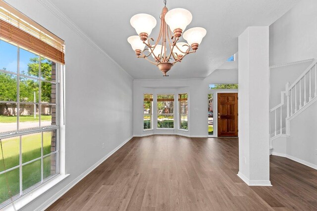 1809 Johnson Way, Round Rock, TX 78681 - foyer entrance with a wealth of natural light, wood finished floors, and a notable chandelier