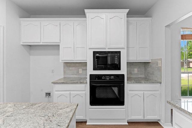 1809 Johnson Way, Round Rock, TX 78681 - kitchen featuring white cabinets, light stone counters, black appliances, and backsplash