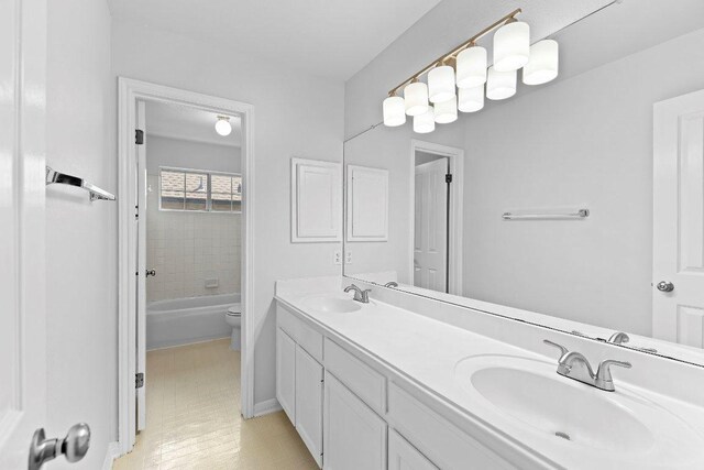 1809 Johnson Way, Round Rock, TX 78681 - bathroom featuring toilet, baseboards, double vanity, and a sink