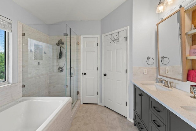 full bathroom featuring a healthy amount of sunlight, a sink, a garden tub, and a stall shower