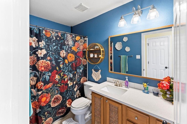 bathroom featuring visible vents, a shower with curtain, toilet, and vanity