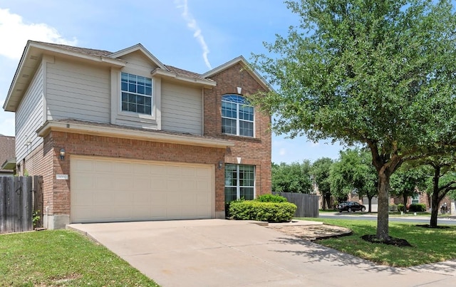 traditional-style home featuring driveway, a garage, brick siding, fence, and a shingled roof