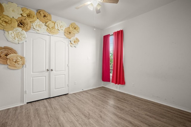 243 Mancos Dr, Georgetown, TX 78626 - unfurnished bedroom with baseboards, a ceiling fan, and wood finished floors