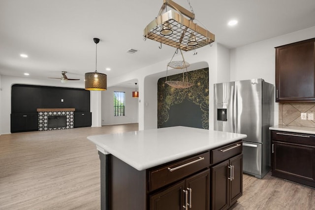 243 Mancos Dr, Georgetown, TX 78626 - kitchen with light countertops, stainless steel refrigerator with ice dispenser, ceiling fan, and light wood-type flooring
