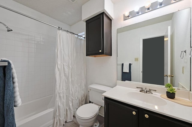 bathroom with vanity, shower / tub combo, and toilet