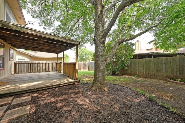 view of yard with a fenced backyard and a wooden deck