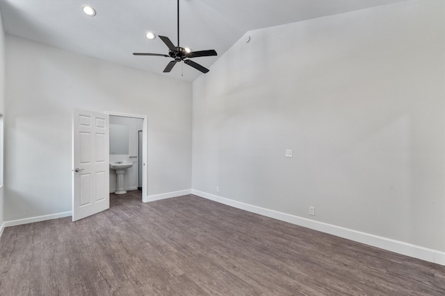 unfurnished bedroom featuring recessed lighting, high vaulted ceiling, baseboards, and dark wood-type flooring