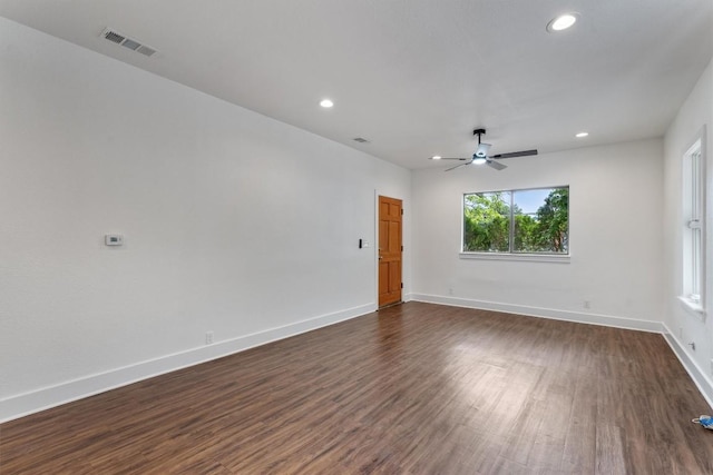 empty room featuring visible vents, a ceiling fan, dark wood-style flooring, and recessed lighting