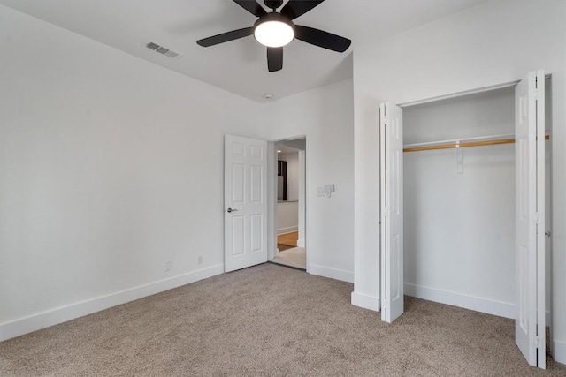 unfurnished bedroom featuring carpet floors, baseboards, visible vents, and a closet