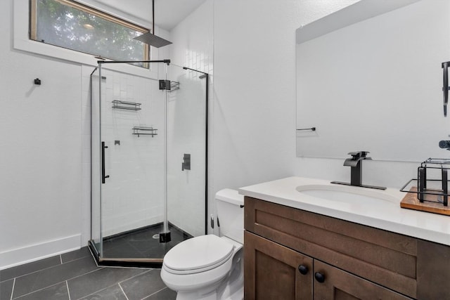 bathroom featuring vanity, toilet, tile patterned floors, and a stall shower