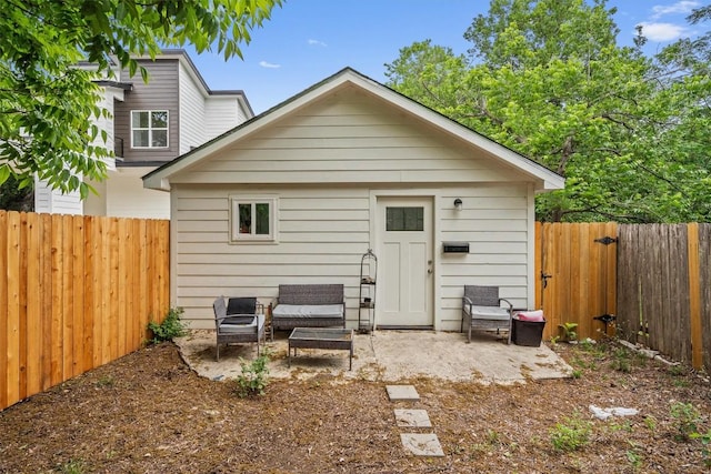 rear view of property with a patio and a fenced backyard