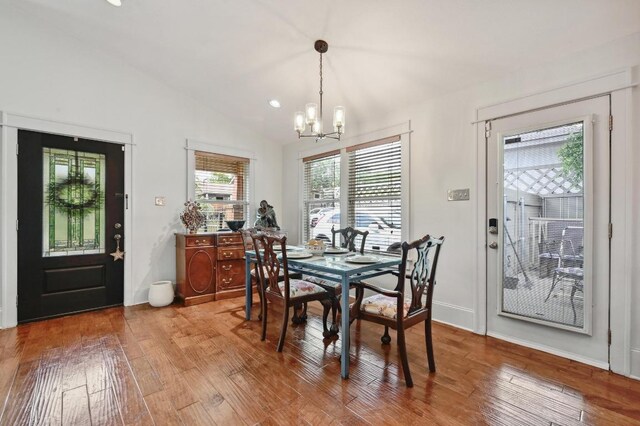 dining area with a chandelier, light wood-type flooring, vaulted ceiling, recessed lighting, and baseboards