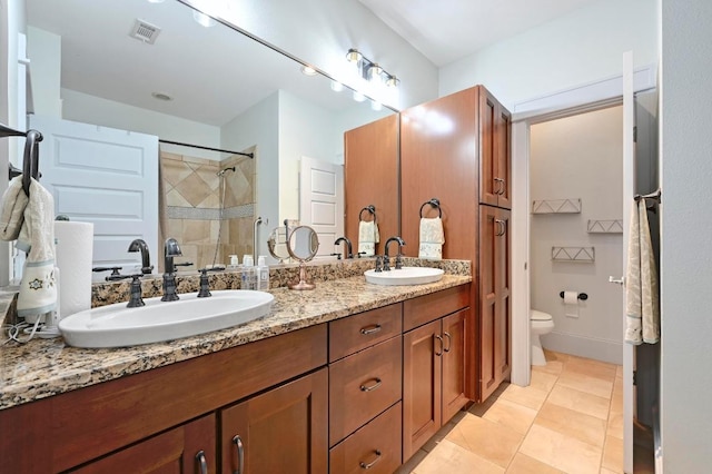 1185 Coleto St, Austin, TX 78702 - bathroom featuring double vanity, tiled shower, and tile patterned flooring
