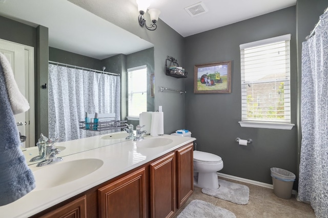 376 Sweet Gum Dr, Kyle, TX 78640 - full bathroom featuring toilet, double vanity, tile patterned flooring, and curtained shower