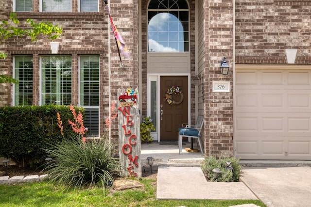 376 Sweet Gum Dr, Kyle, TX 78640 - property entrance featuring brick siding and a garage