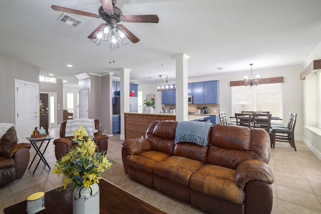 376 Sweet Gum Dr, Kyle, TX 78640 - living area featuring a chandelier, light tile patterned floors, ornate columns, a ceiling fan, and baseboards