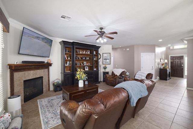 376 Sweet Gum Dr, Kyle, TX 78640 - living area with light tile patterned floors, ceiling fan, a fireplace, recessed lighting, and crown molding