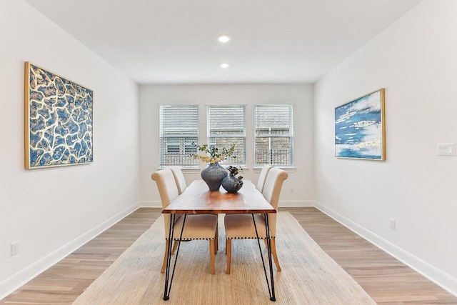 dining room with recessed lighting, baseboards, and light wood finished floors