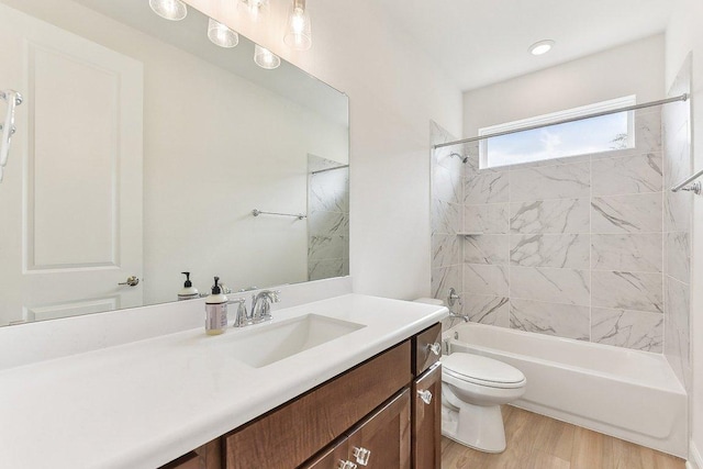 bathroom featuring vanity, bathtub / shower combination, toilet, and wood finished floors