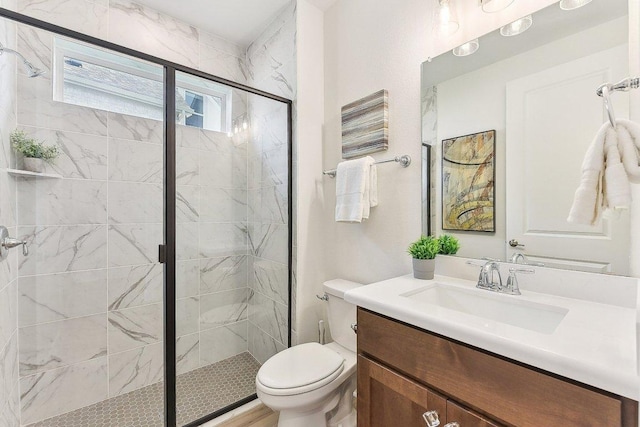 full bath featuring vanity, toilet, and a stall shower
