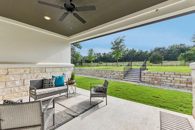 view of patio featuring fence, a ceiling fan, and outdoor lounge area