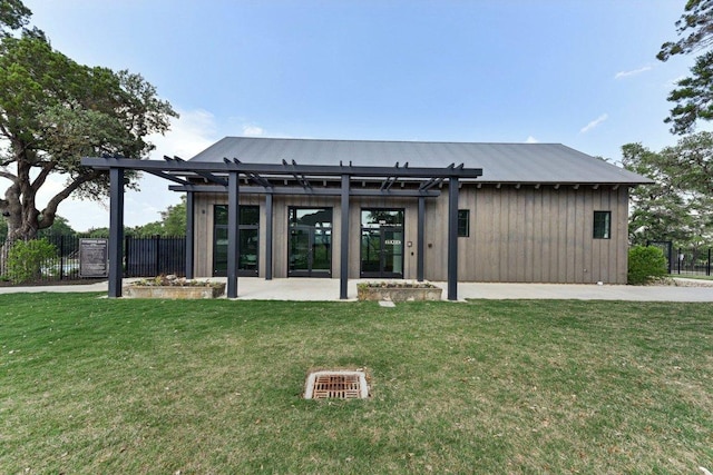 back of property with a yard, a pergola, fence, and a patio area