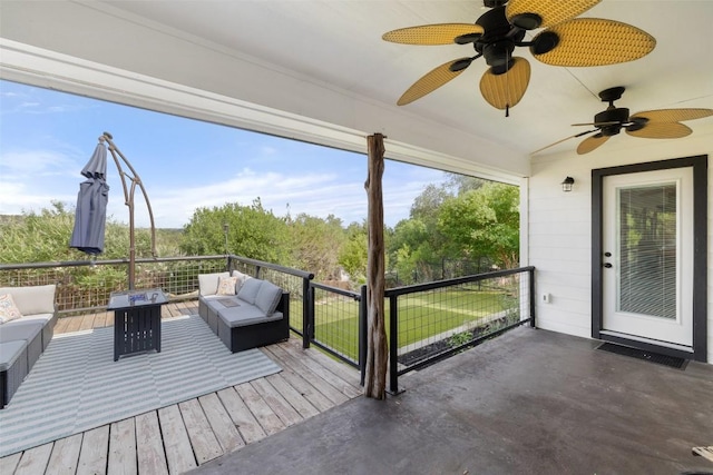 wooden deck featuring an outdoor living space and a ceiling fan