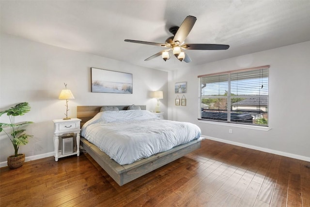 bedroom with dark wood-style flooring, baseboards, and ceiling fan